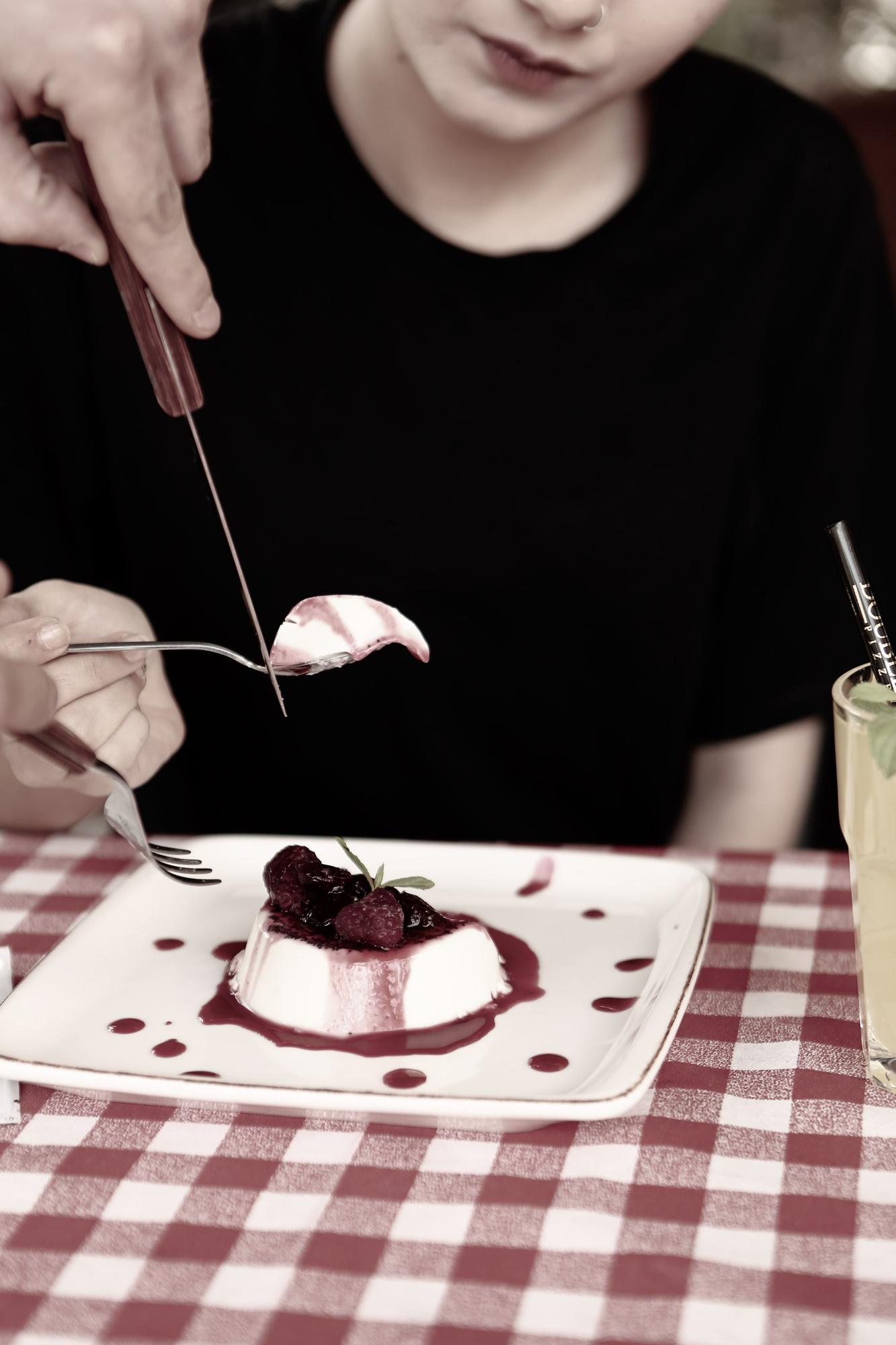 Hands plating dessert with tweezers